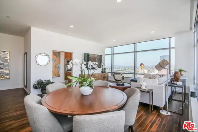 a dining room with furniture window and wooden floor