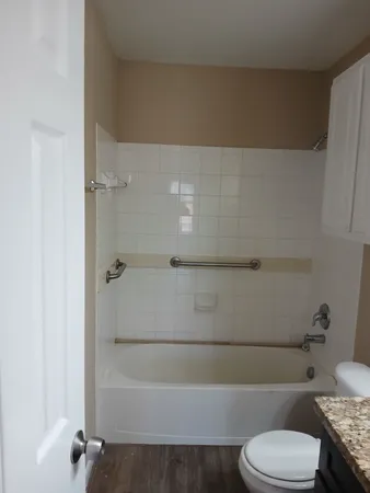 a bathroom with a toilet and a shower