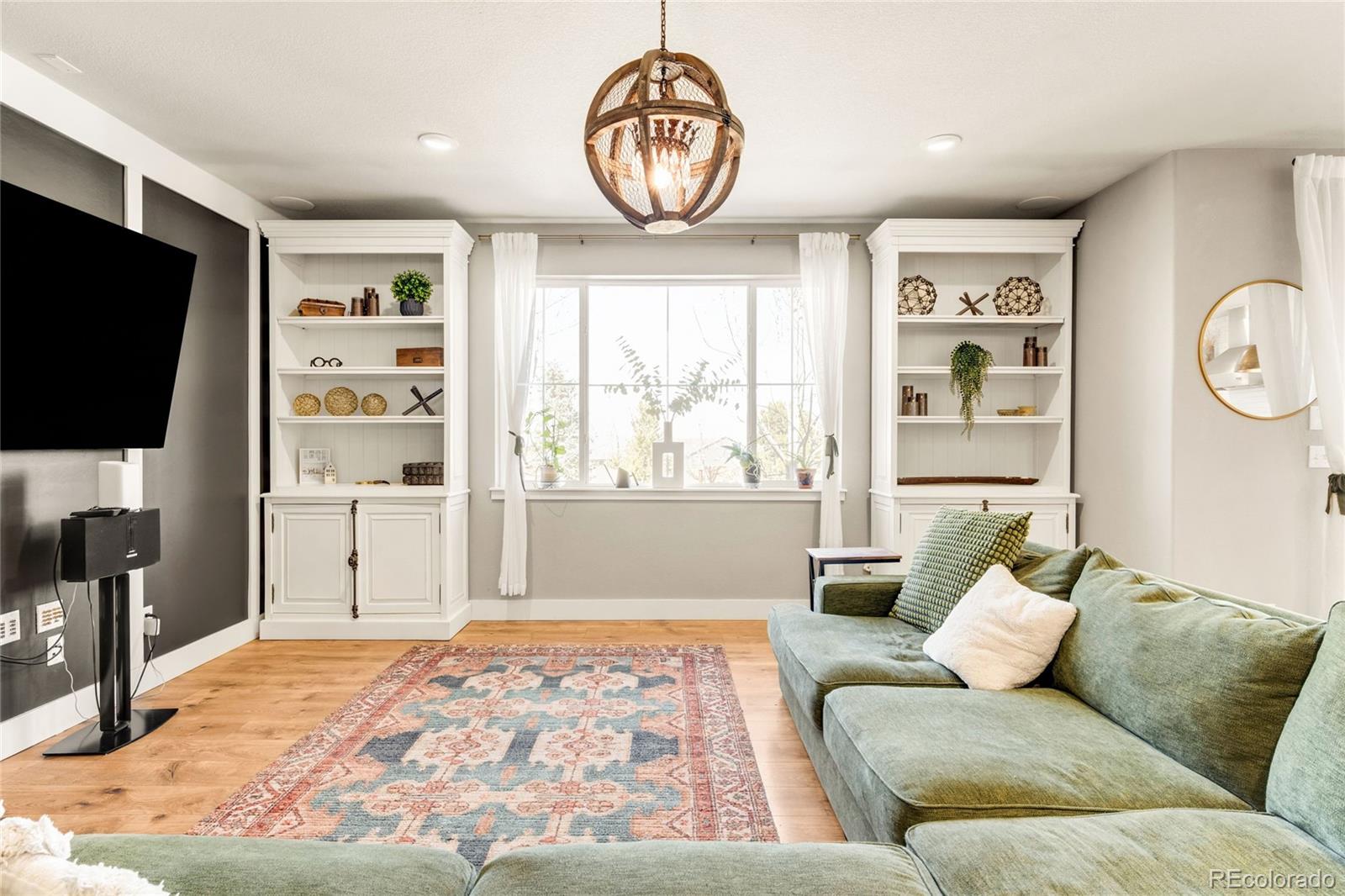 683 Tiger Lily Way Highlands Ranch, CO 80126 - Photo 14 of 50 a living room with furniture a window and a flat screen tv