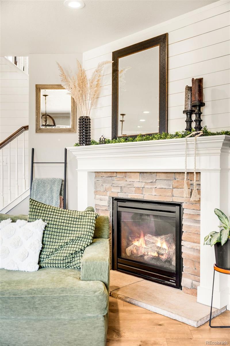 683 Tiger Lily Way Highlands Ranch, CO 80126 - Photo 16 of 50 a living room with a fireplace furniture a flat screen tv and a fireplace