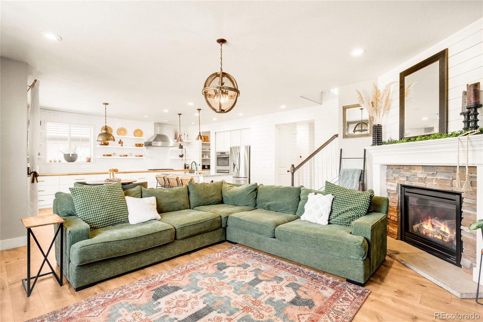 683 Tiger Lily Way Highlands Ranch, CO 80126 - Photo 17 of 50 a living room with furniture a fireplace and a large window
