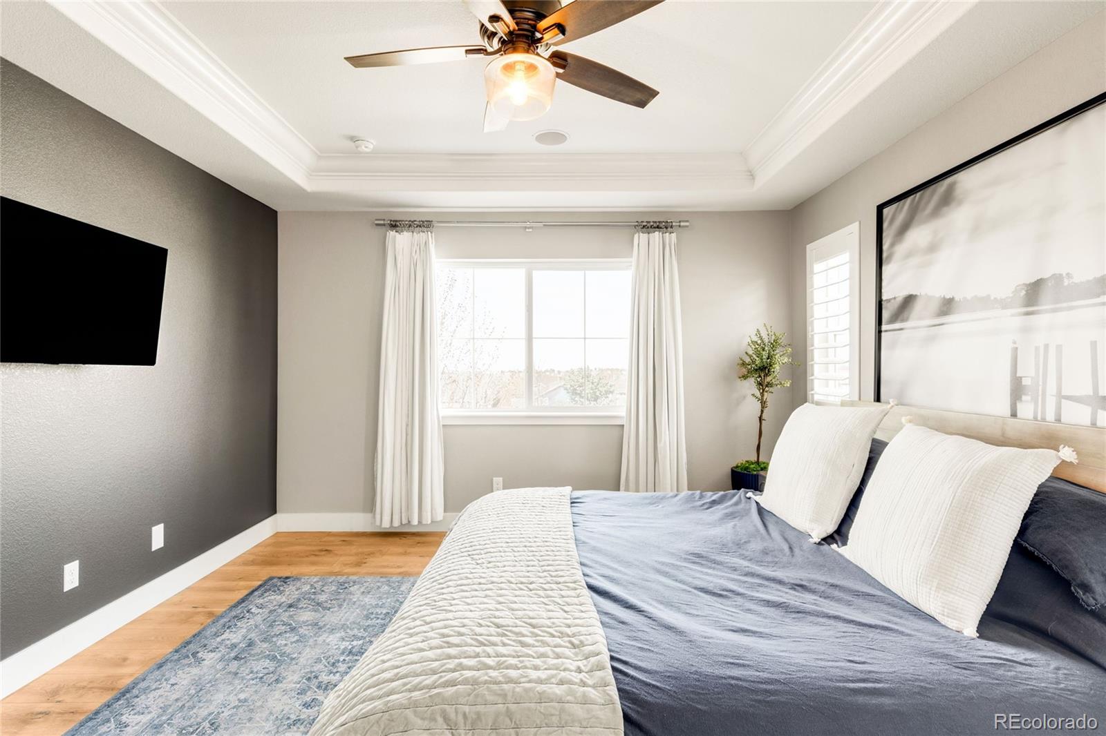 683 Tiger Lily Way Highlands Ranch, CO 80126 - Photo 23 of 50 a bedroom with a bed and a flat screen tv