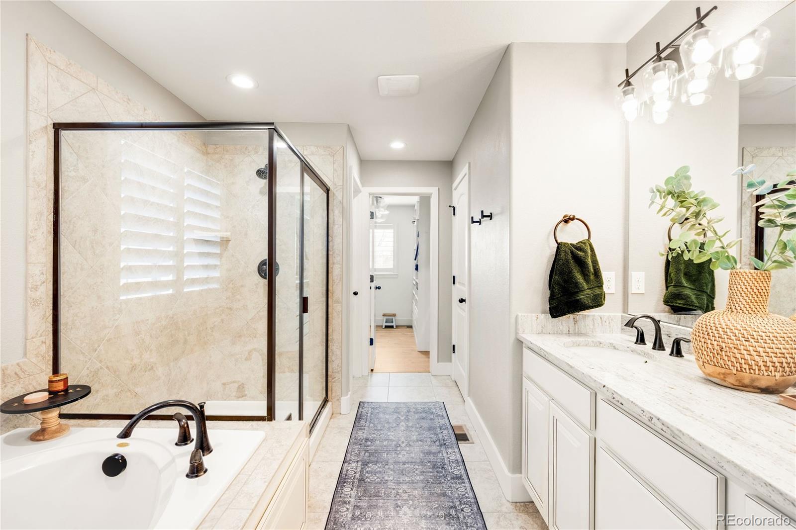 683 Tiger Lily Way Highlands Ranch, CO 80126 - Photo 27 of 50 a bathroom with a double vanity sink mirror and shower