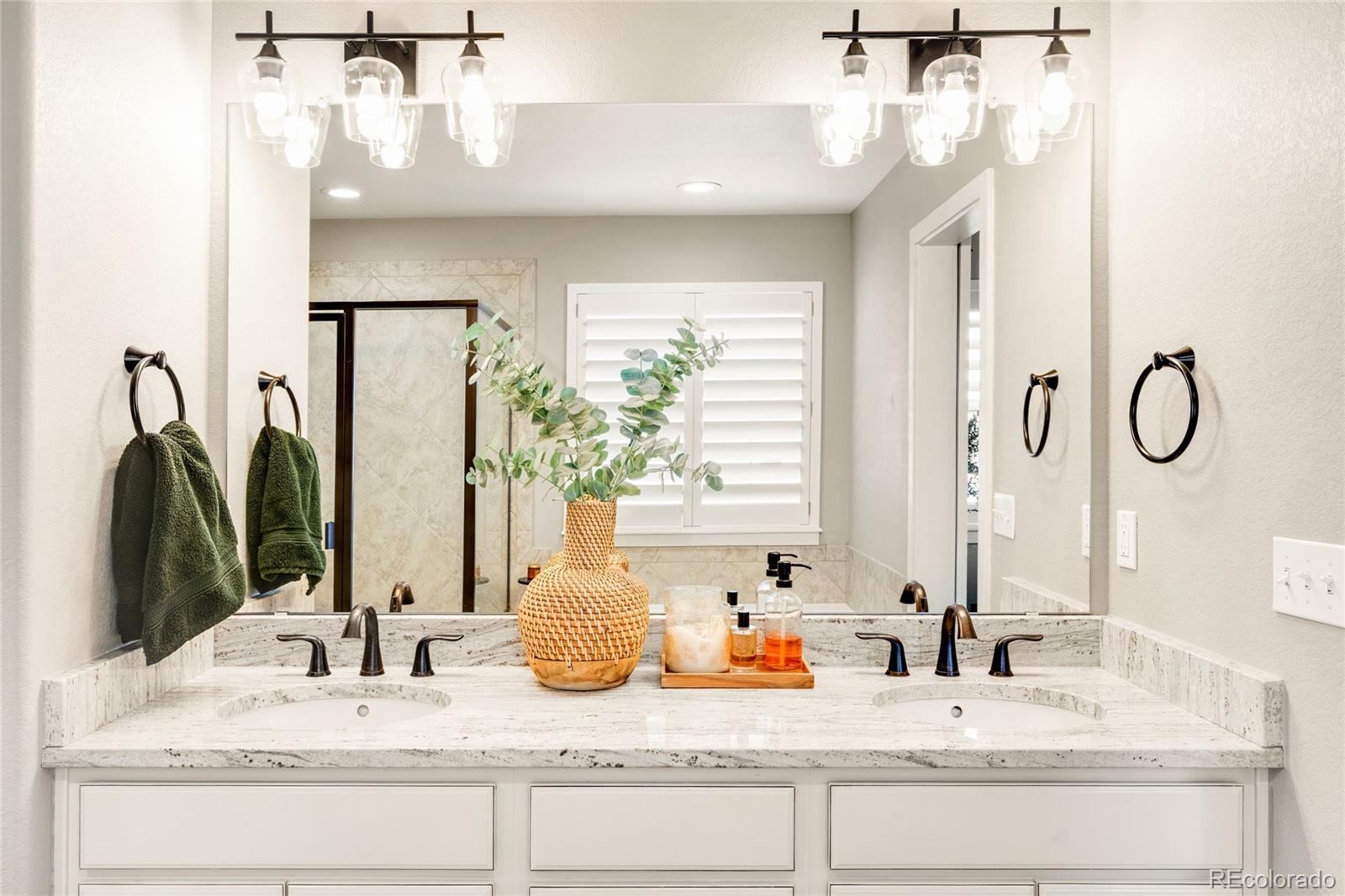 683 Tiger Lily Way Highlands Ranch, CO 80126 - Photo 28 of 50 a bathroom with double vanity sinks a vanity and a mirror