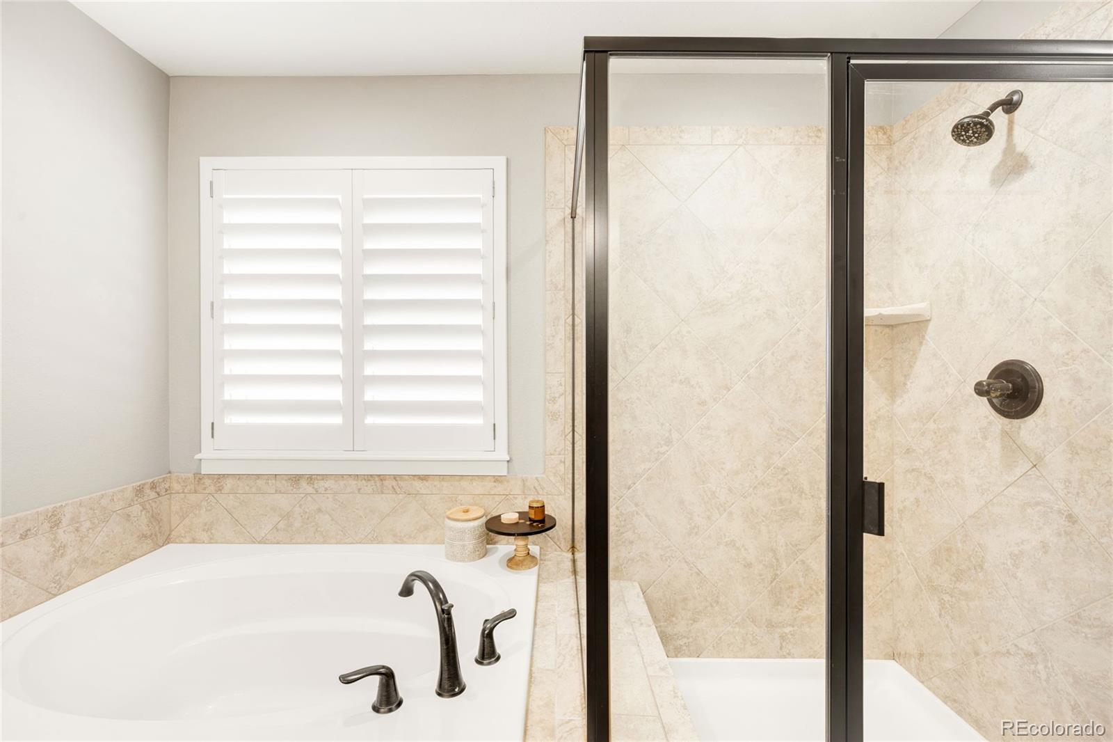 683 Tiger Lily Way Highlands Ranch, CO 80126 - Photo 29 of 50 a bathroom with a tub and shower