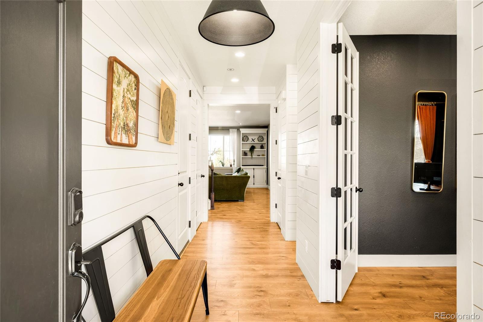 683 Tiger Lily Way Highlands Ranch, CO 80126 - Photo 3 of 50 a view of a hallway with furniture and wooden floor