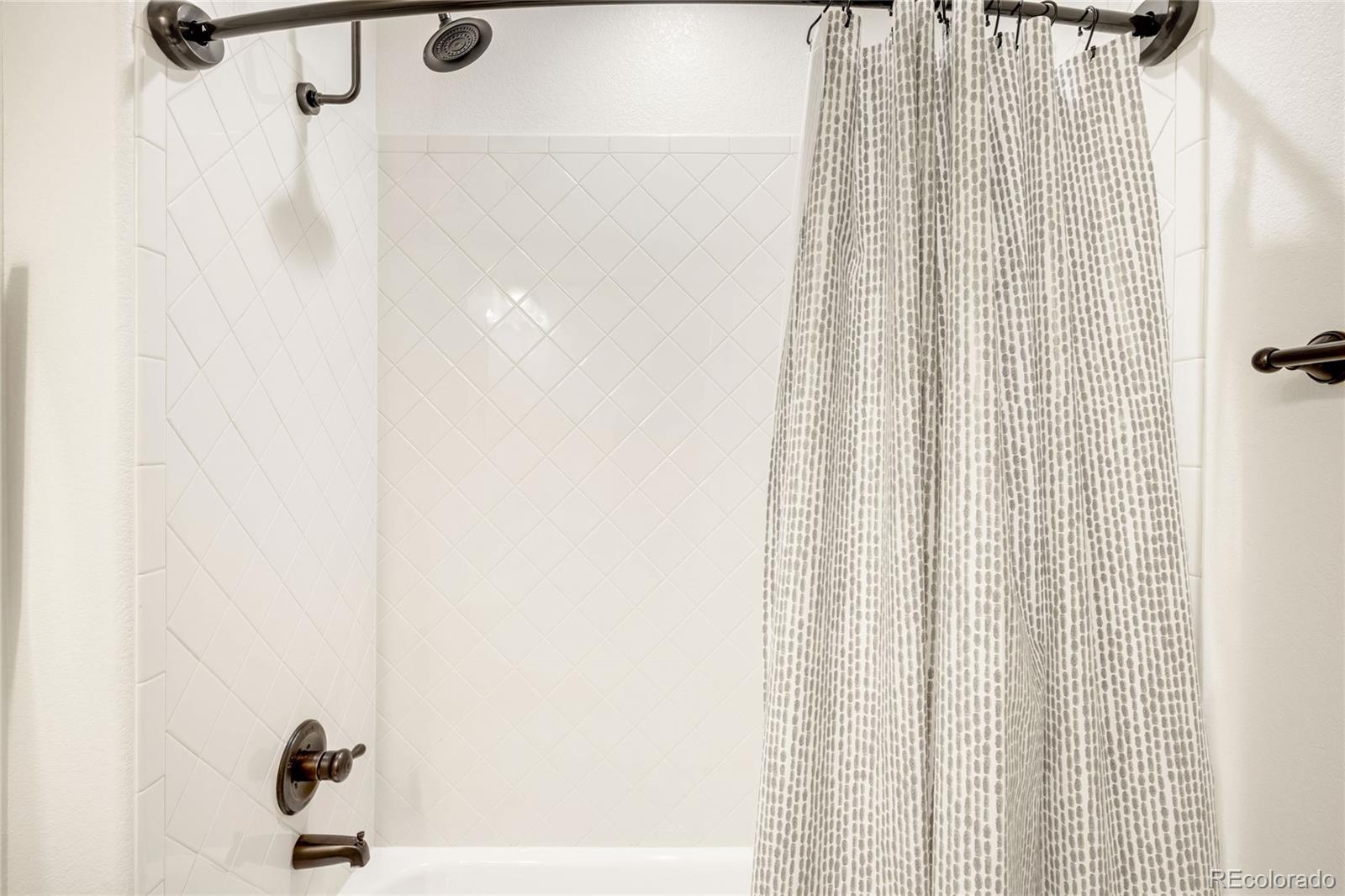 683 Tiger Lily Way Highlands Ranch, CO 80126 - Photo 32 of 50 a bathroom with a shower curtain