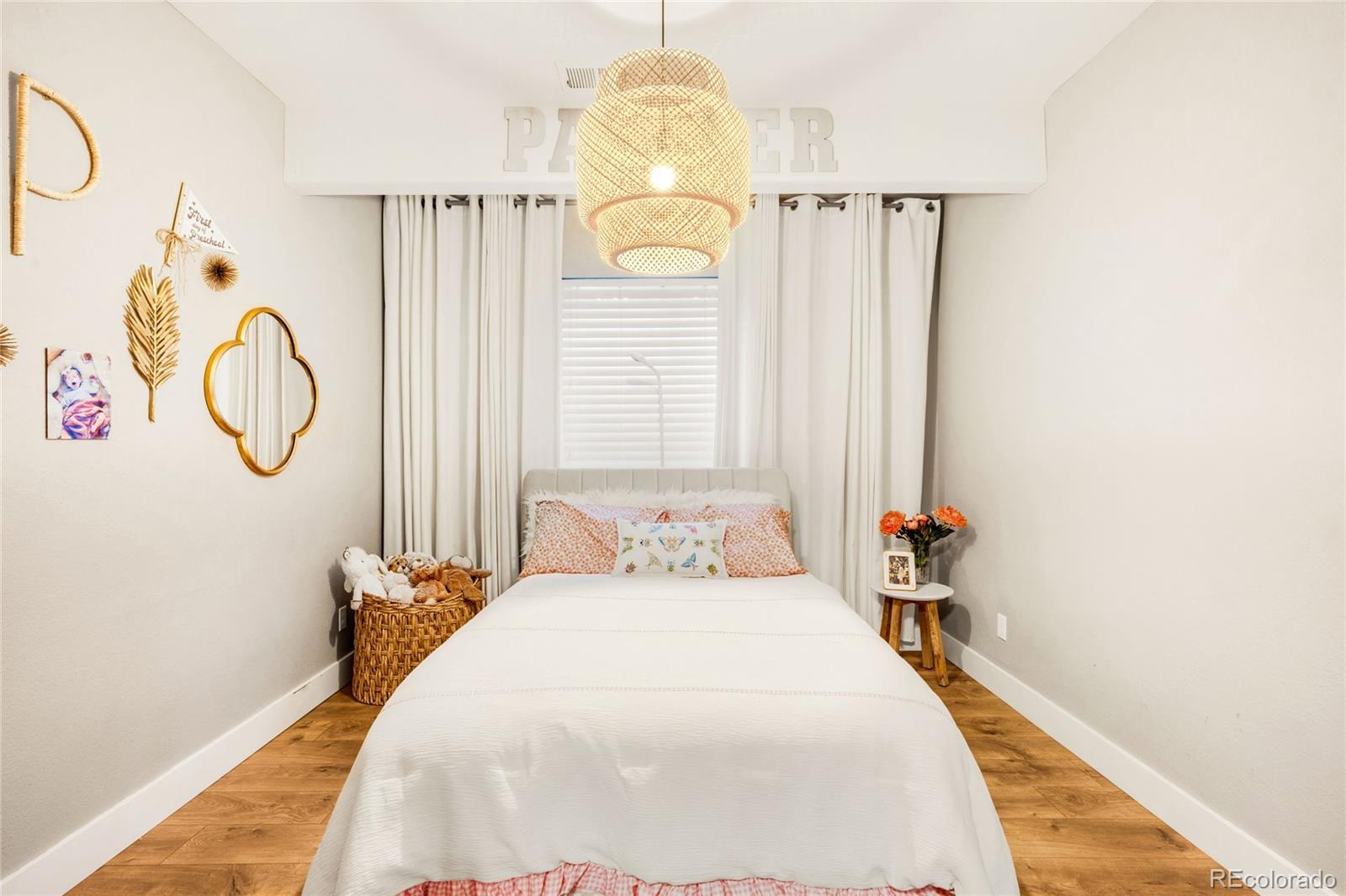 683 Tiger Lily Way Highlands Ranch, CO 80126 - Photo 35 of 50 a bedroom with a bed and a chandelier