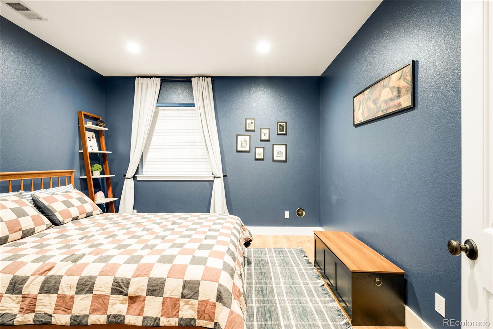 683 Tiger Lily Way Highlands Ranch, CO 80126 - Photo 37 of 50 a bedroom with a bed and a lamp