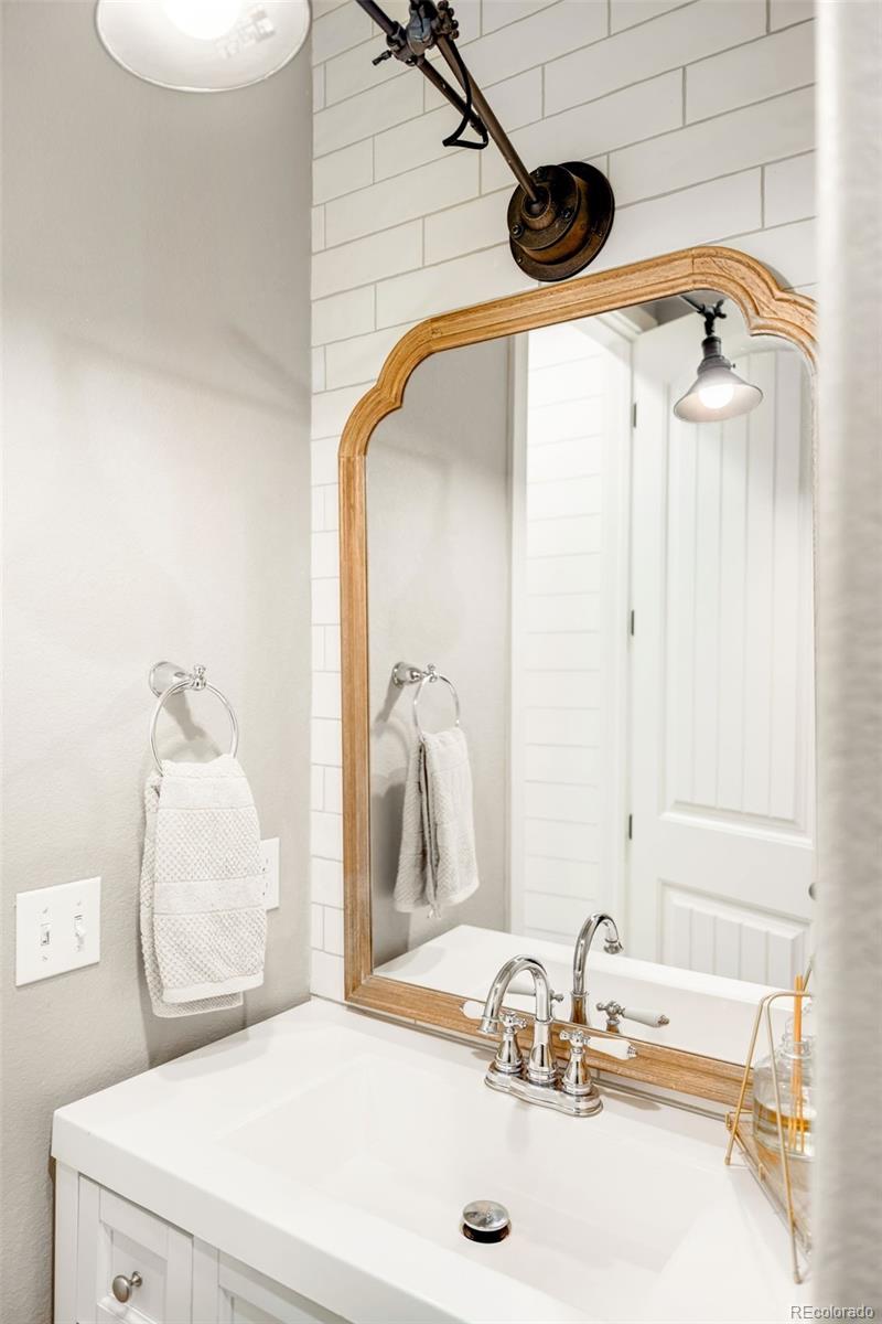 683 Tiger Lily Way Highlands Ranch, CO 80126 - Photo 40 of 50 a bathroom with a sink and a mirror