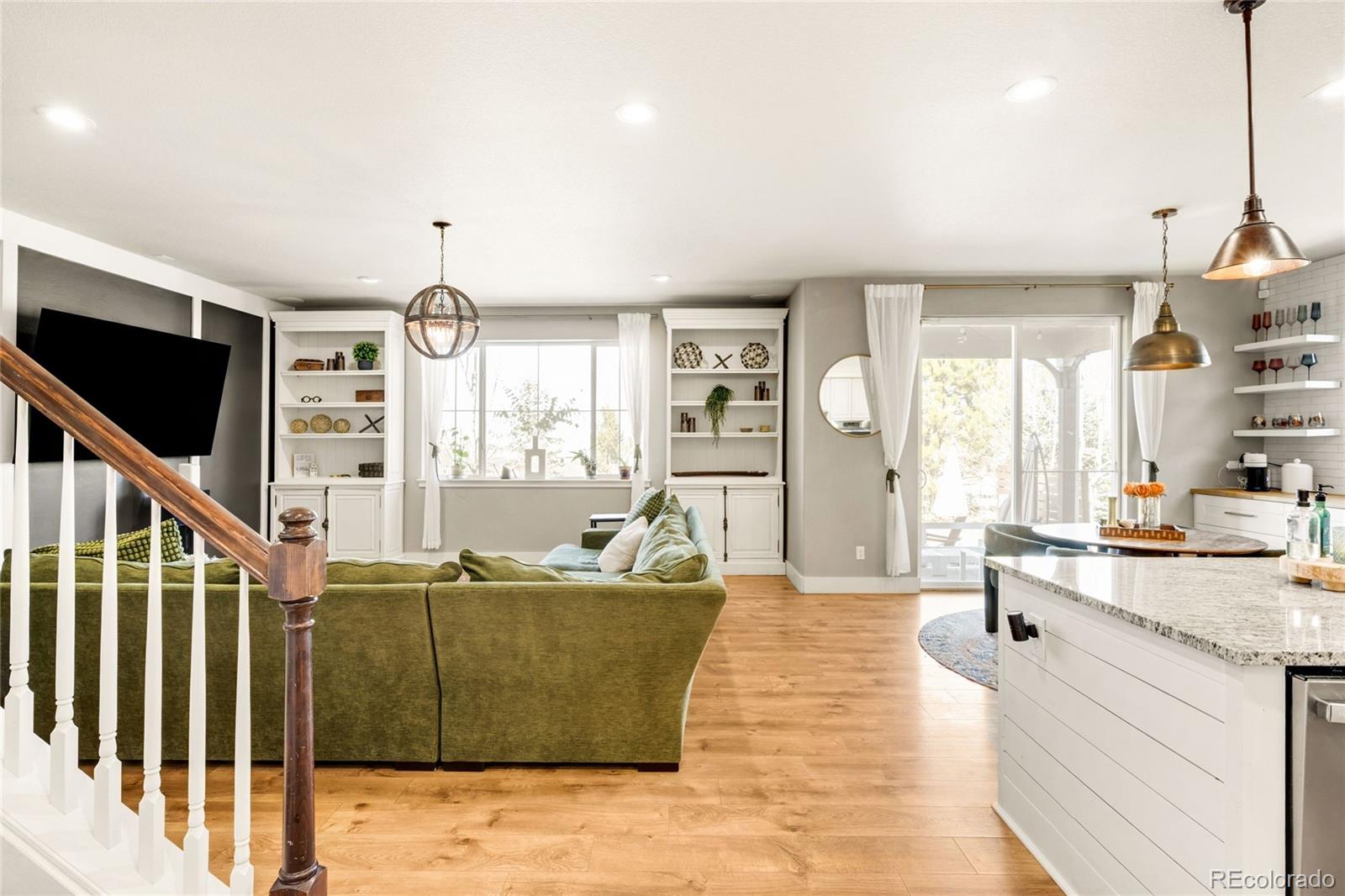 683 Tiger Lily Way Highlands Ranch, CO 80126 - Photo 4 of 50 a living room with furniture windows and a flat screen tv