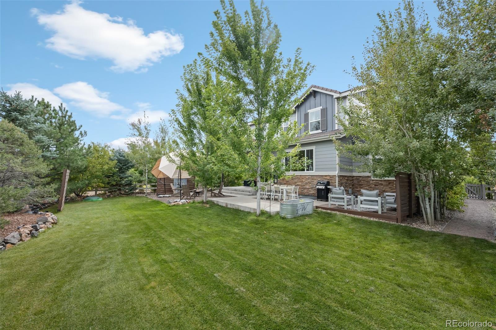 683 Tiger Lily Way Highlands Ranch, CO 80126 - Photo 41 of 50 a view of a house with backyard and sitting area