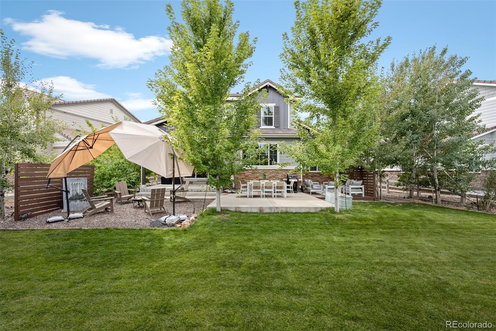 683 Tiger Lily Way Highlands Ranch, CO 80126 - Photo 42 of 50 a view of a house with a backyard porch and sitting area