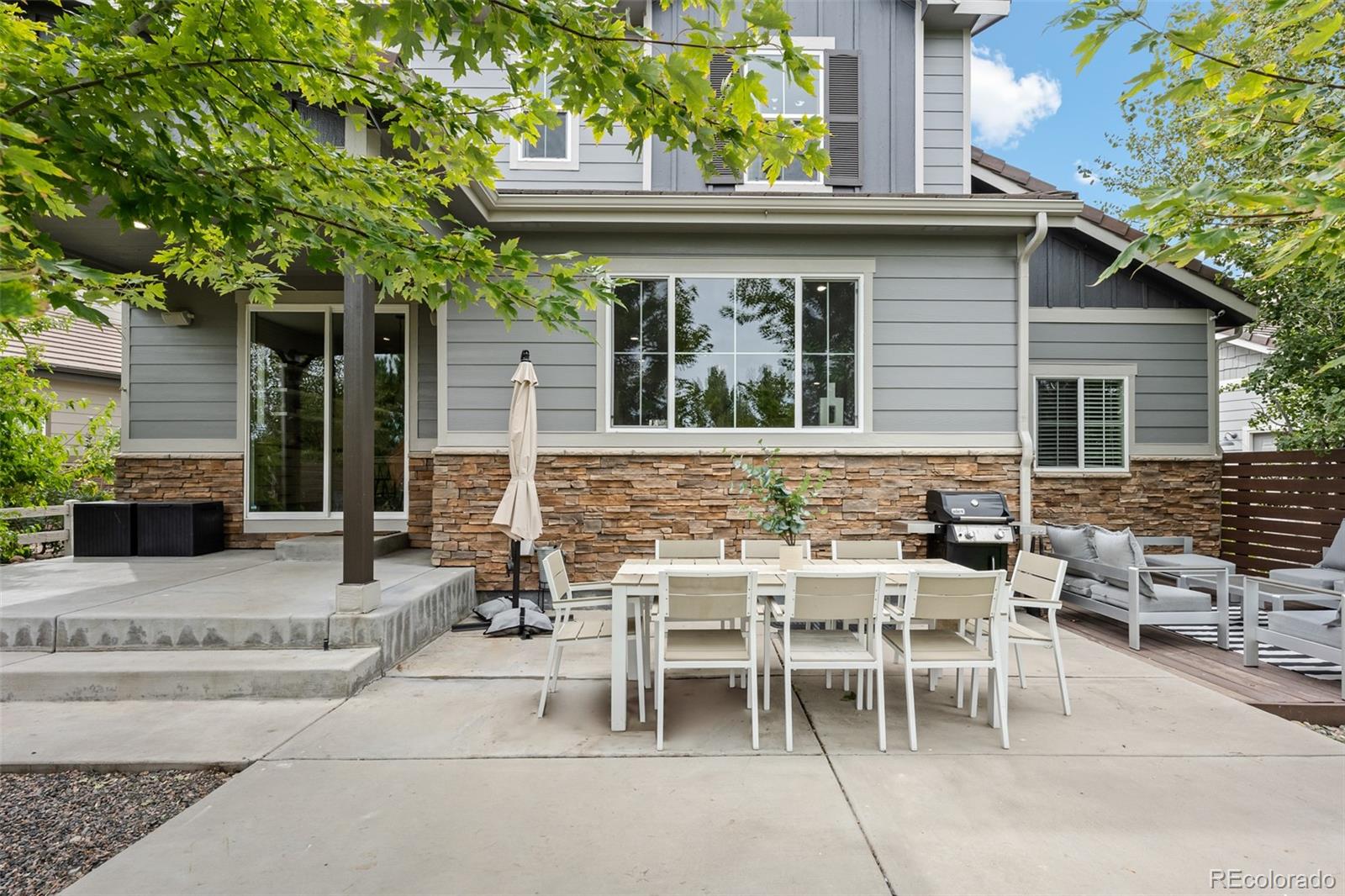 683 Tiger Lily Way Highlands Ranch, CO 80126 - Photo 43 of 50 a view of a patio with table and chairs and potted plants