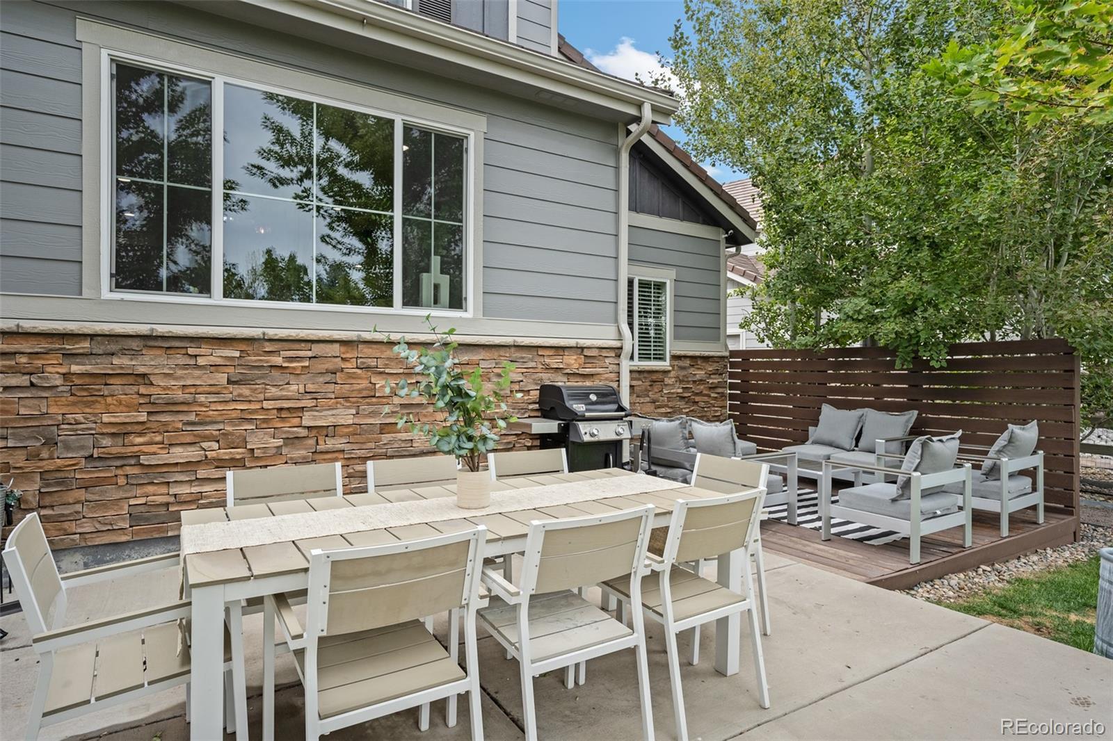 683 Tiger Lily Way Highlands Ranch, CO 80126 - Photo 44 of 50 a view of a patio with table and chairs and potted plants
