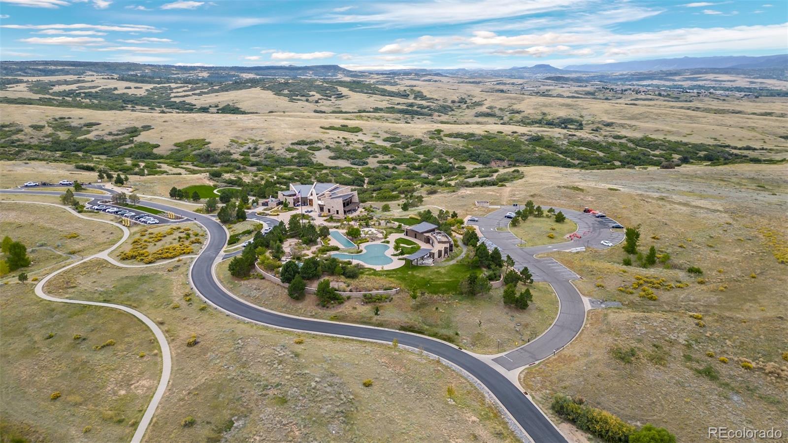 683 Tiger Lily Way Highlands Ranch, CO 80126 - Photo 47 of 50 a view of a swimming pool with a lot of trees in the background