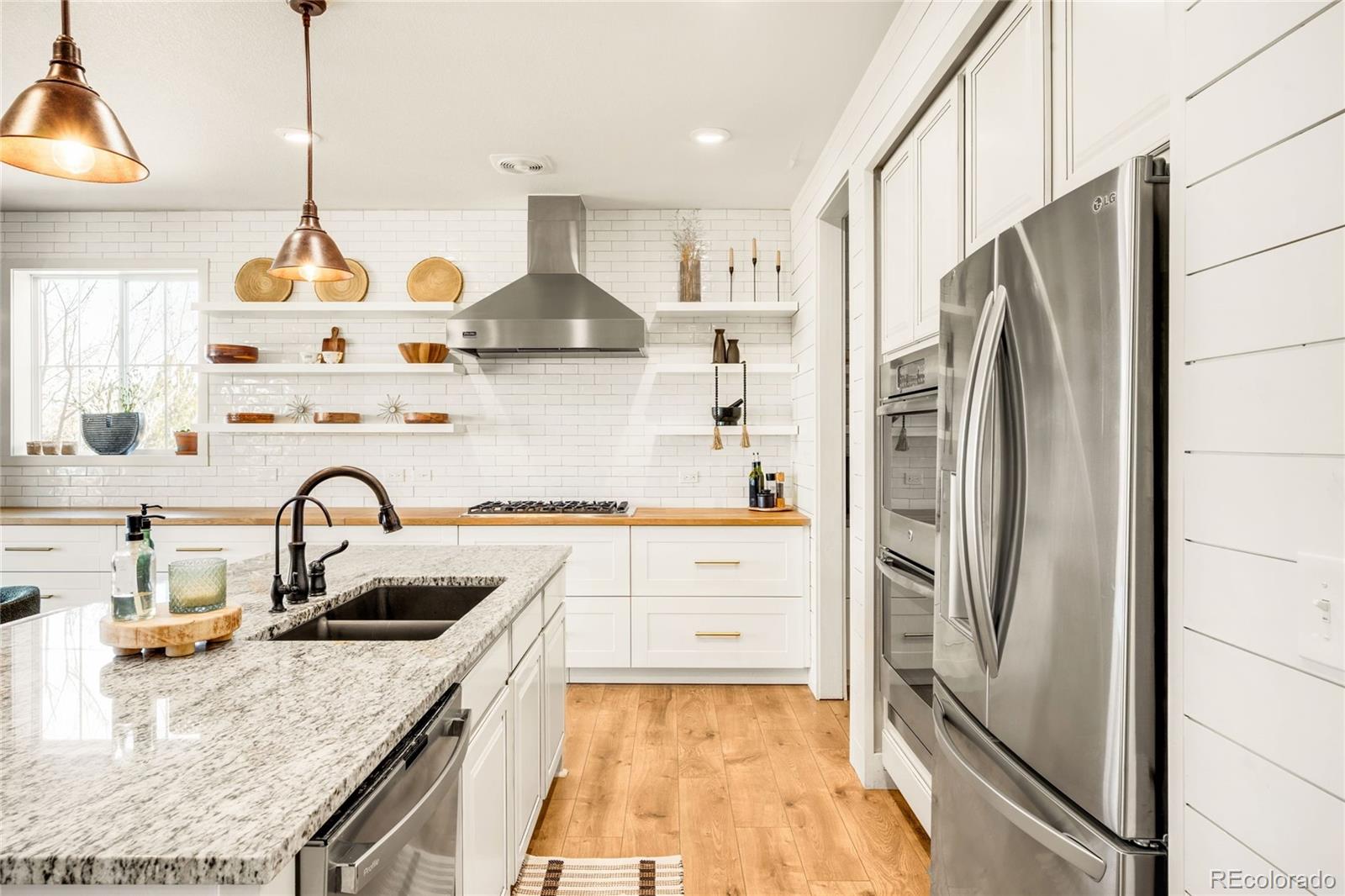 683 Tiger Lily Way Highlands Ranch, CO 80126 - Photo 5 of 50 a kitchen with granite countertop a refrigerator and a sink
