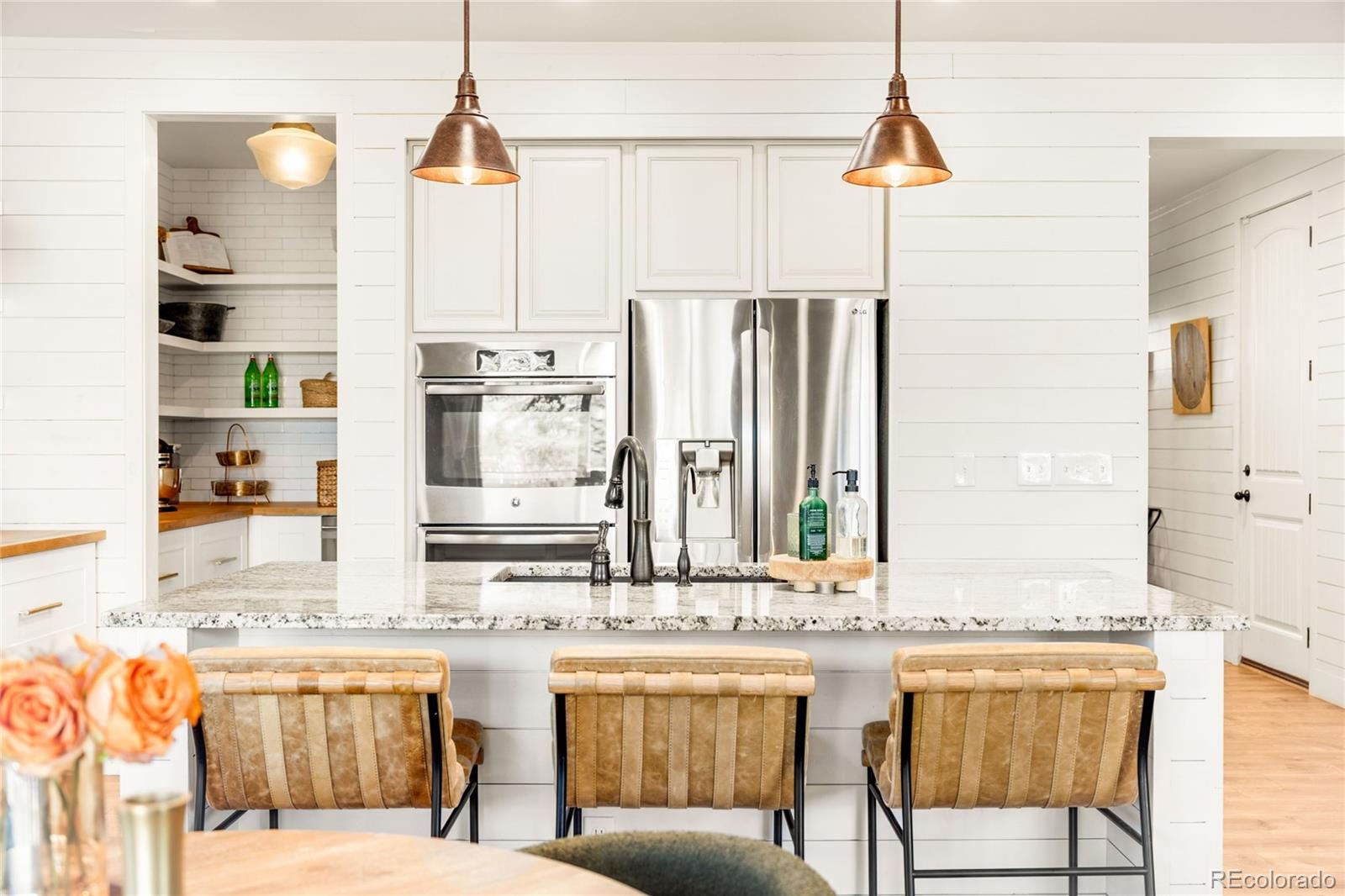 683 Tiger Lily Way Highlands Ranch, CO 80126 - Photo 7 of 50 a kitchen with stainless steel appliances kitchen island granite countertop a table and chairs