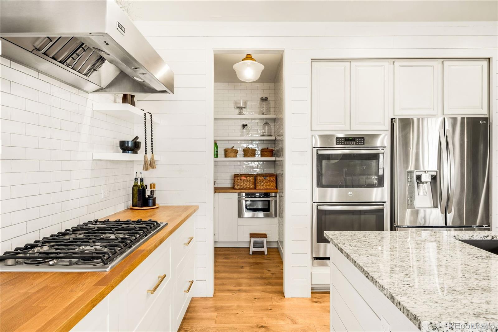 683 Tiger Lily Way Highlands Ranch, CO 80126 - Photo 8 of 50 a kitchen with refrigerator and cabinets