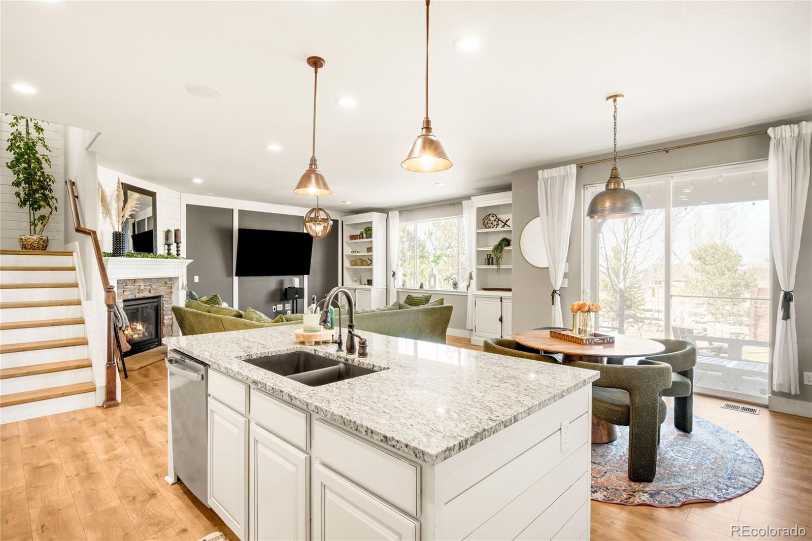 683 Tiger Lily Way Highlands Ranch, CO 80126 - Photo 10 of 50 a kitchen view with living room and flat screen tv
