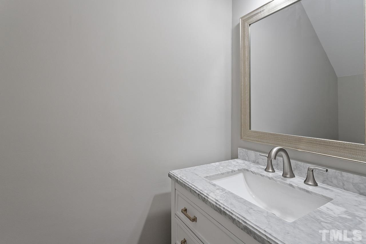 1404 Kent Road Raleigh, NC 27606 - Photo 11 of 28 a bathroom with a sink and a mirror