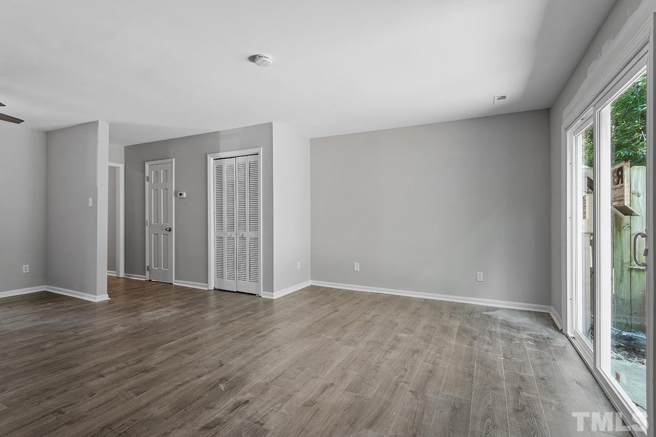 1404 Kent Road Raleigh, NC 27606 - Photo 13 of 28 a view of an empty room with wooden floor and a window