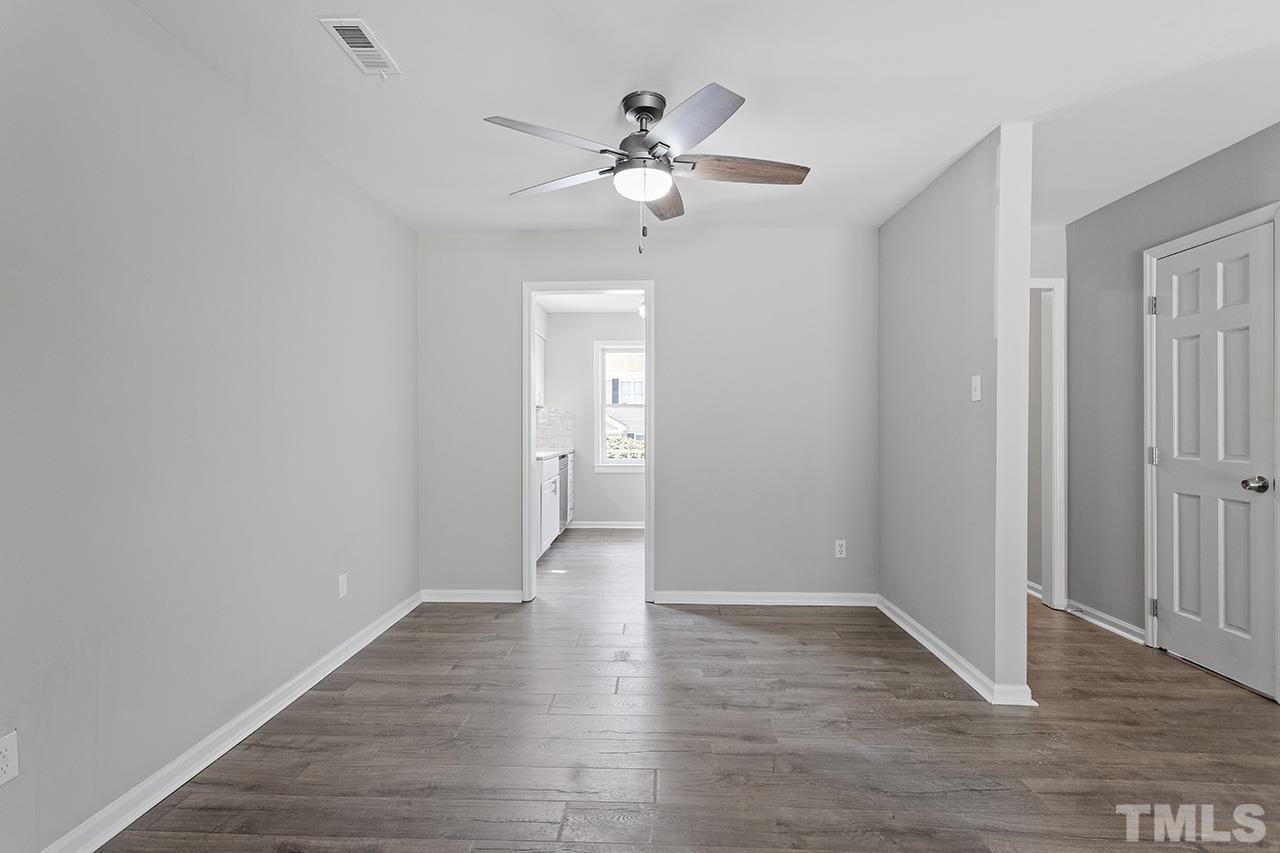 1404 Kent Road Raleigh, NC 27606 - Photo 15 of 28 a view of an empty room with wooden floor