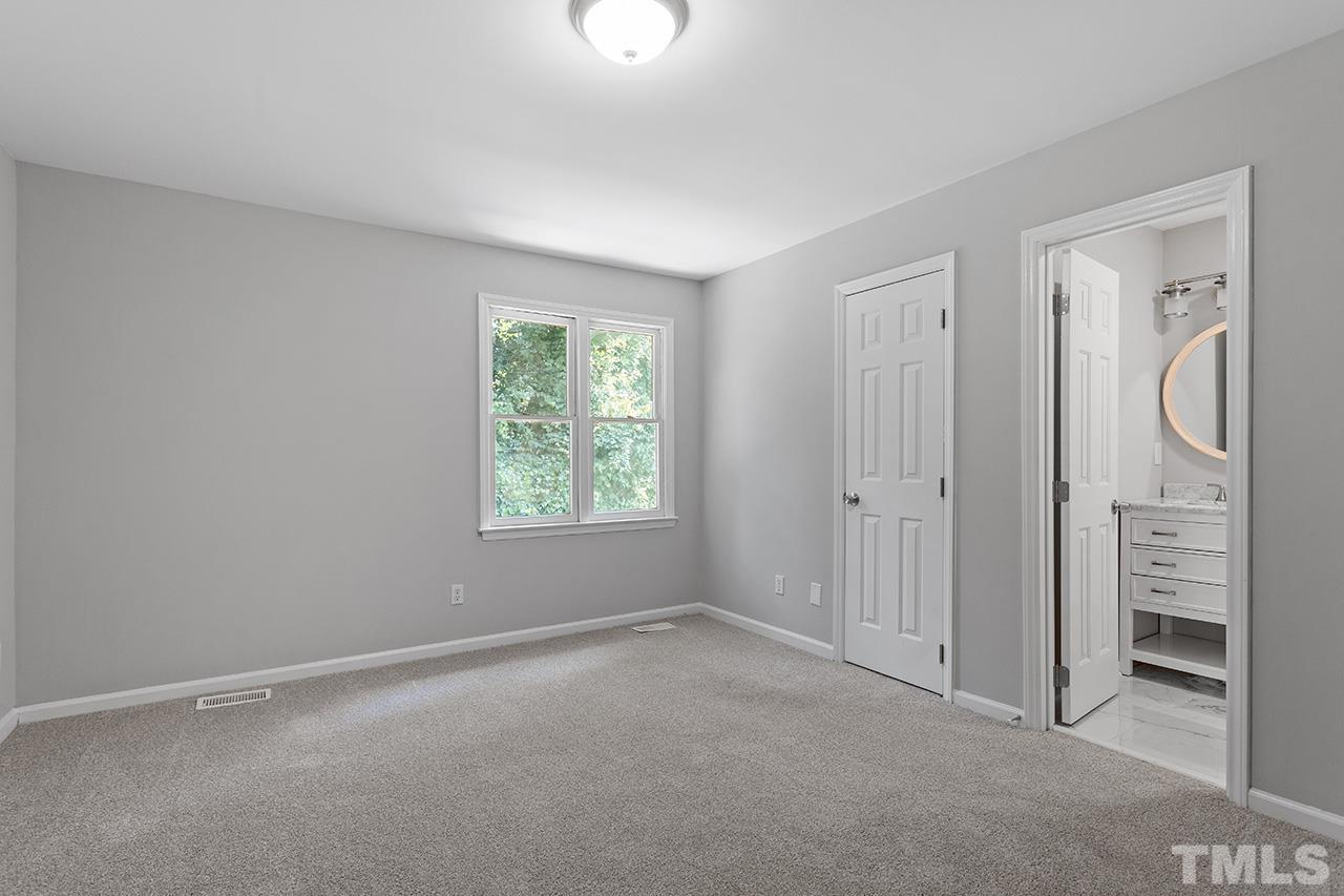 1404 Kent Road Raleigh, NC 27606 - Photo 16 of 28 an empty room with windows and closet