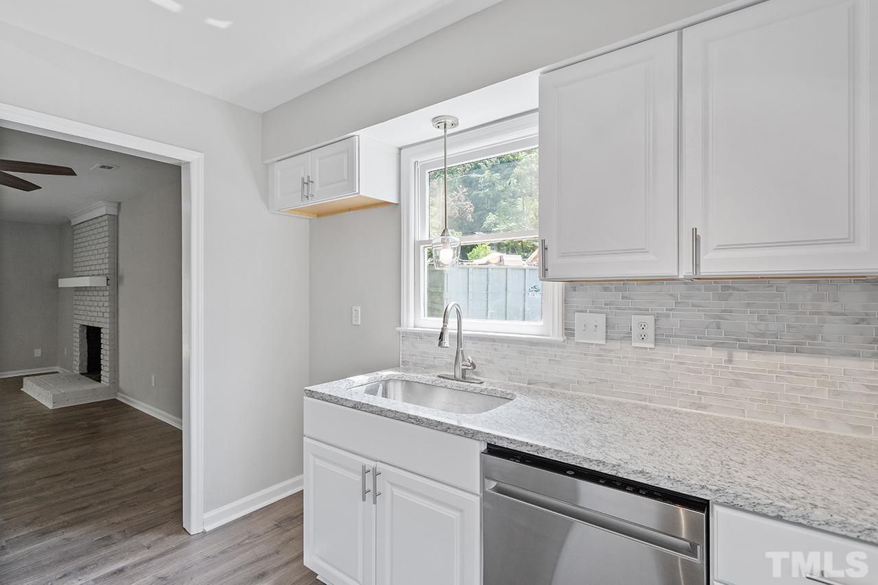 1404 Kent Road Raleigh, NC 27606 - Photo 5 of 28 a kitchen with a sink cabinets and wooden floor