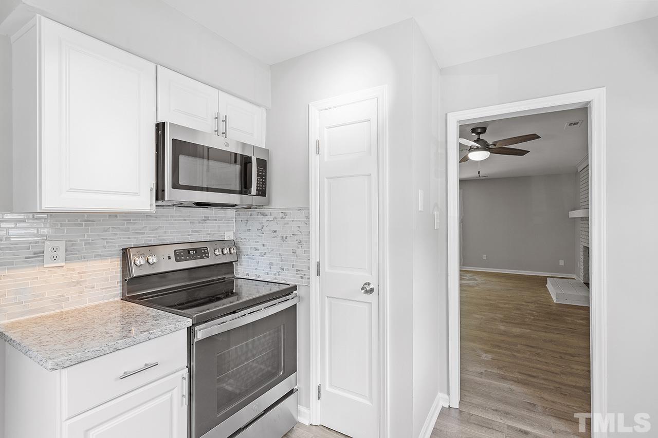 1404 Kent Road Raleigh, NC 27606 - Photo 6 of 28 a kitchen with appliances a sink and cabinets