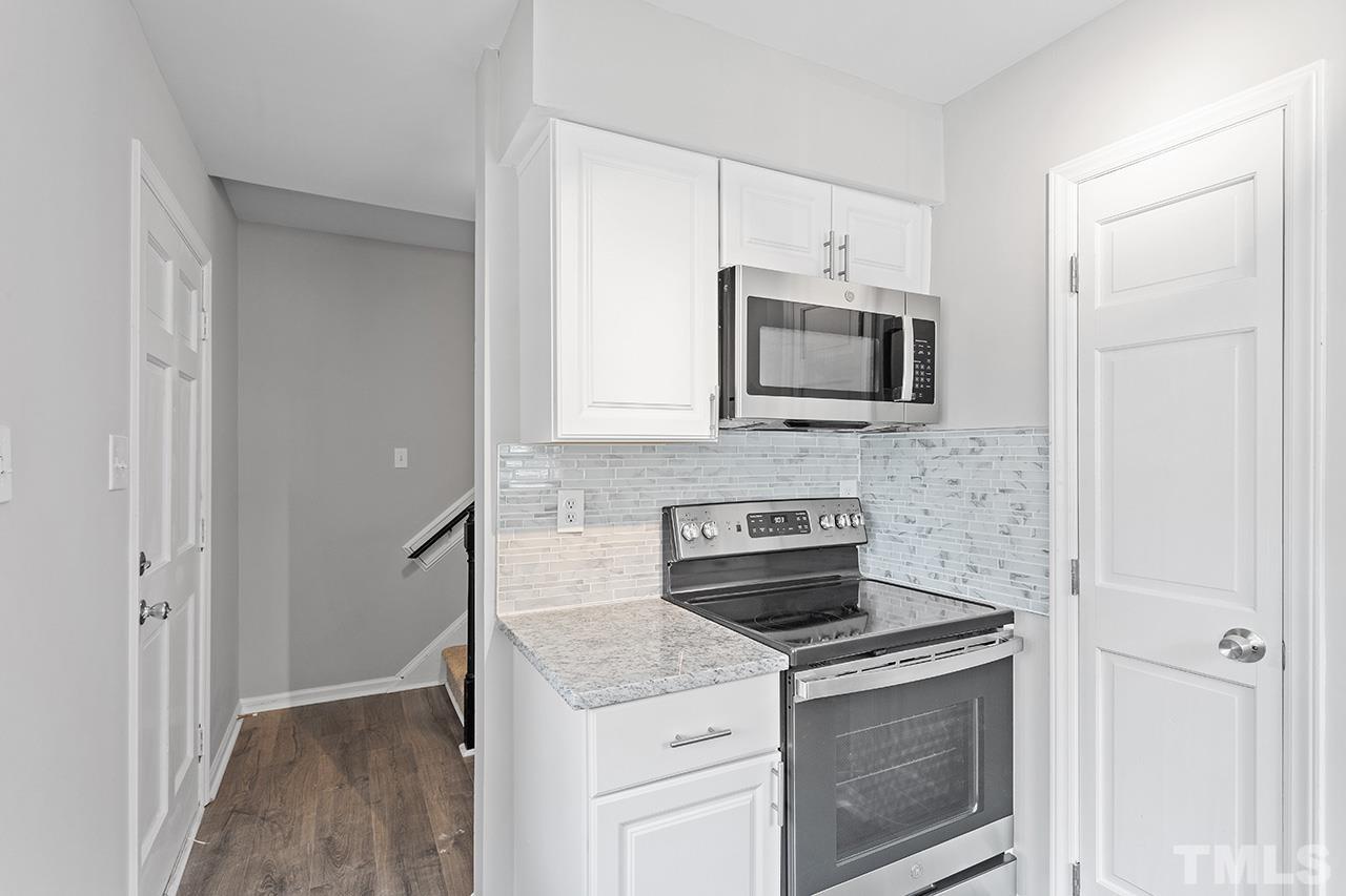 1404 Kent Road Raleigh, NC 27606 - Photo 7 of 28 a kitchen with a stove and a microwave