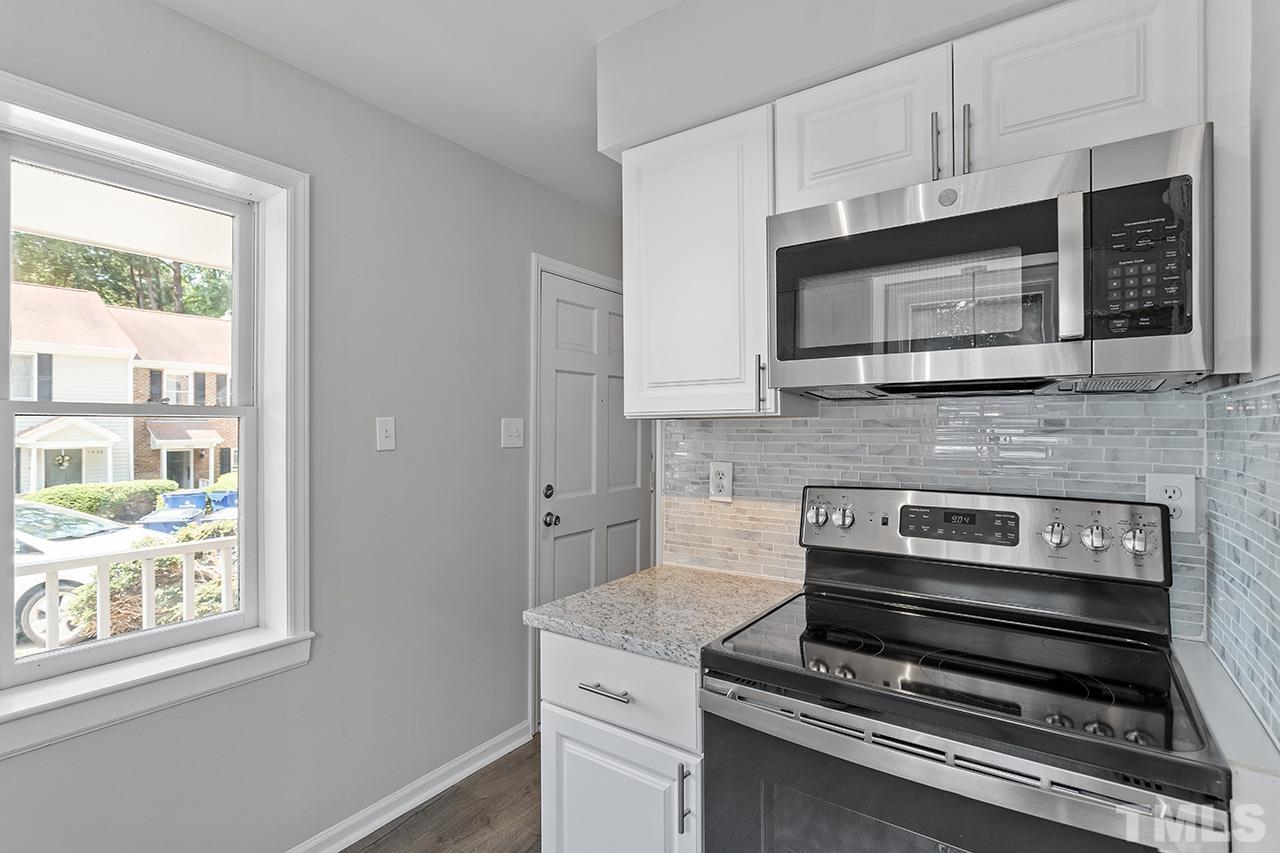 1404 Kent Road Raleigh, NC 27606 - Photo 9 of 28 a kitchen with appliances a sink and cabinets