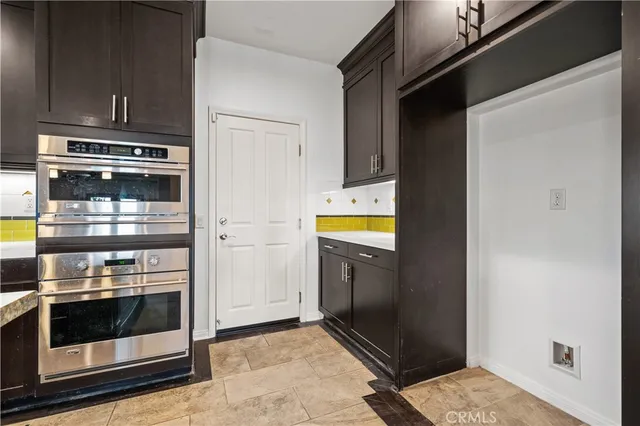 a kitchen with a refrigerator and a stove
