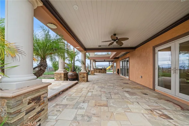 a view of hall way with furniture and floor to ceiling window