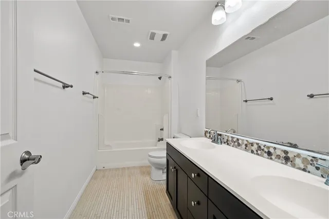 a bathroom with a tub sink and mirror