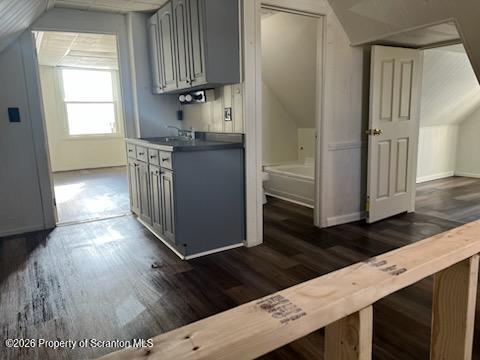 a kitchen with granite countertop wooden cabinets a sink a window and stainless steel appliances