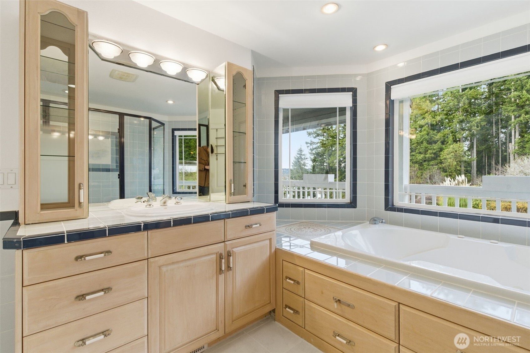 457 East Victor Road Belfair, WA 98528 - Photo 17 of 40 a bathroom with a granite countertop sink mirror and a large window