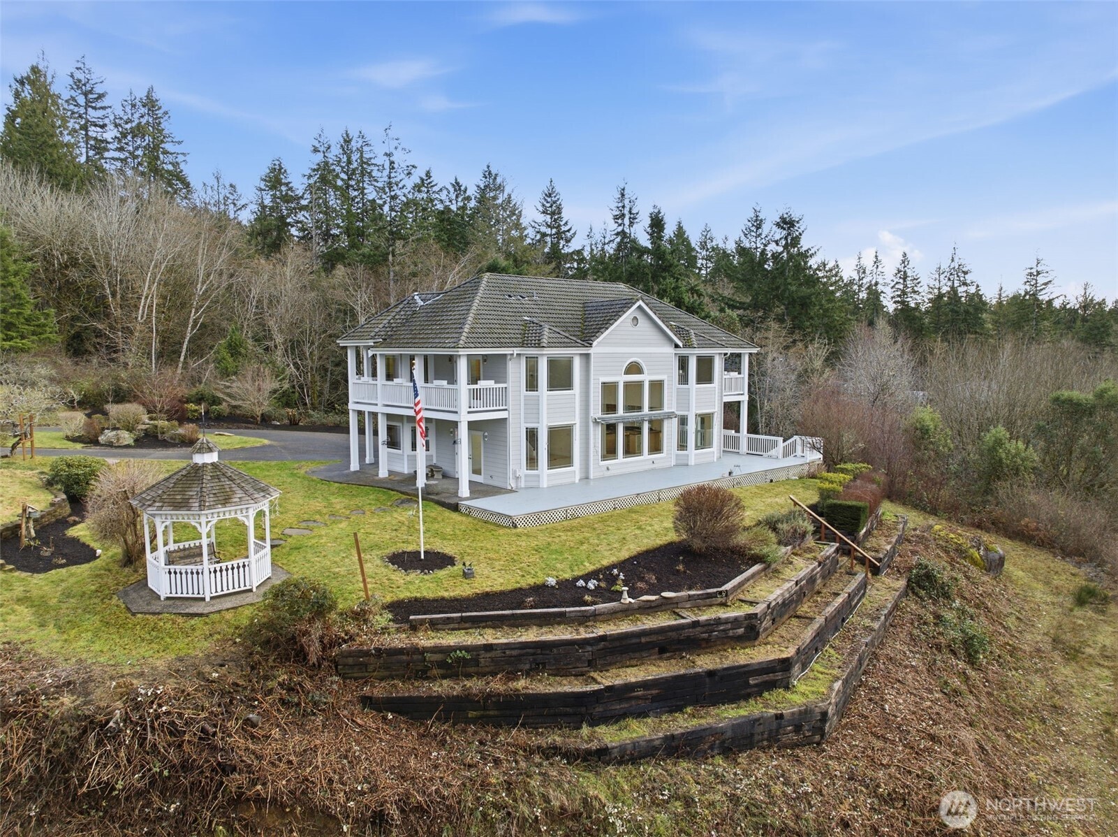 457 East Victor Road Belfair, WA 98528 - Photo 3 of 40 a front view of a house with a yard table and chairs