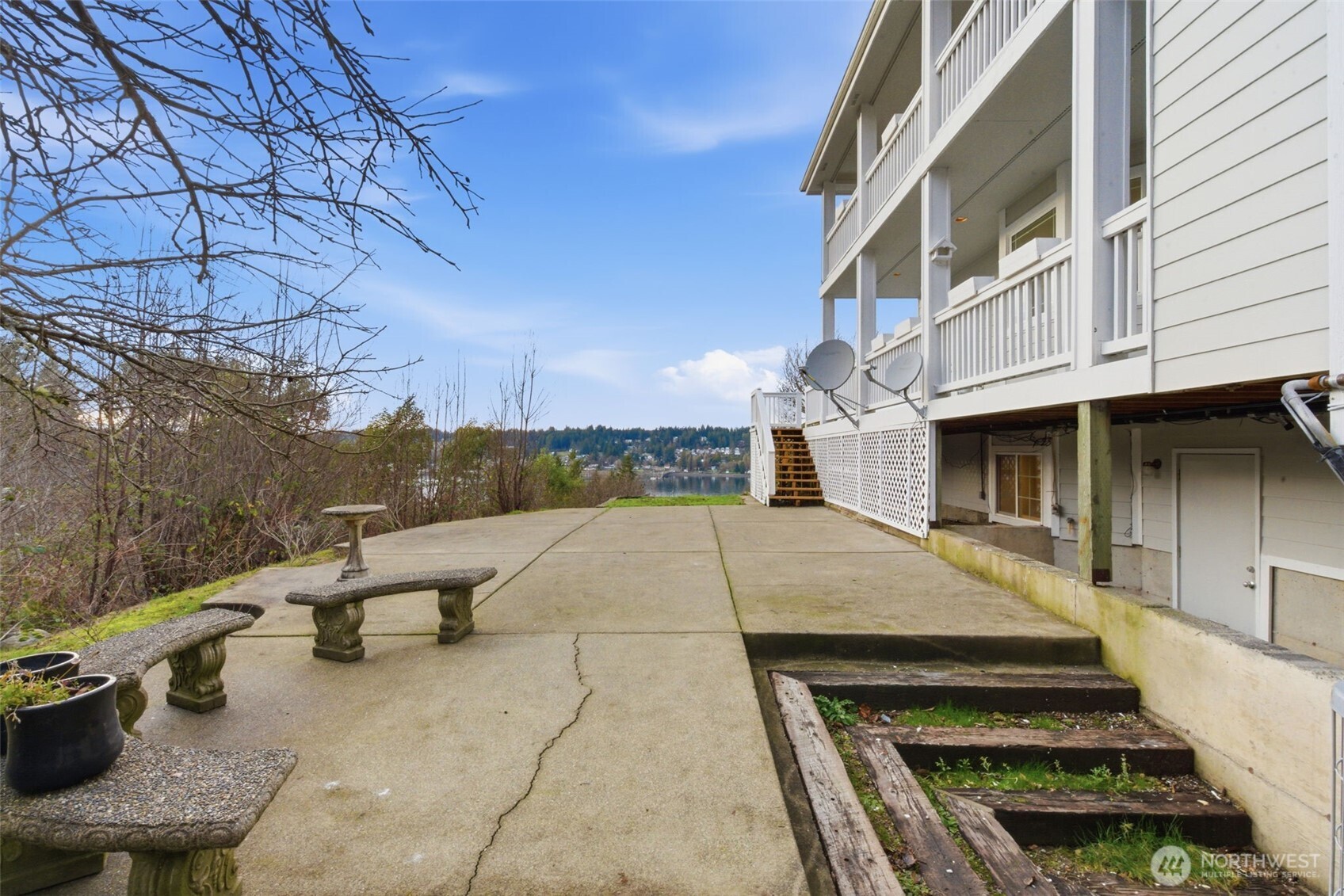 457 East Victor Road Belfair, WA 98528 - Photo 32 of 40 a view of a patio with couches and table and chairs with wooden floor and fence