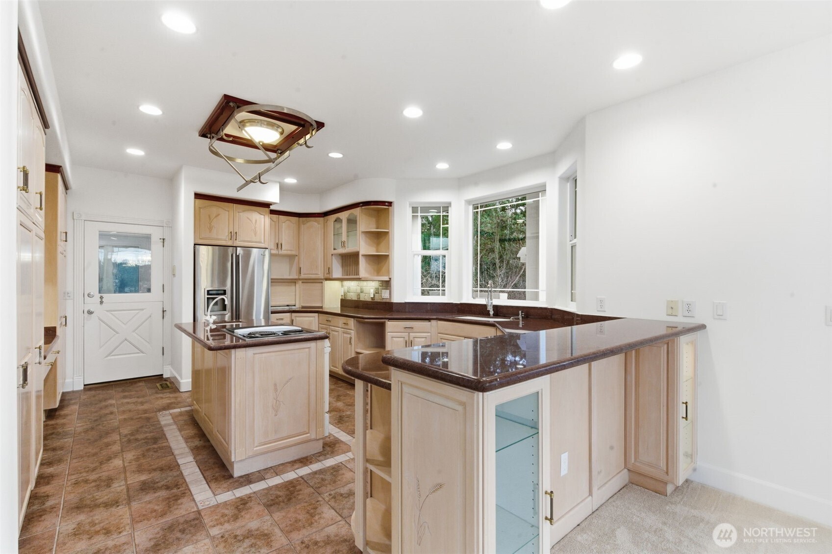 457 East Victor Road Belfair, WA 98528 - Photo 10 of 40 a kitchen with stainless steel appliances granite countertop a sink and a refrigerator