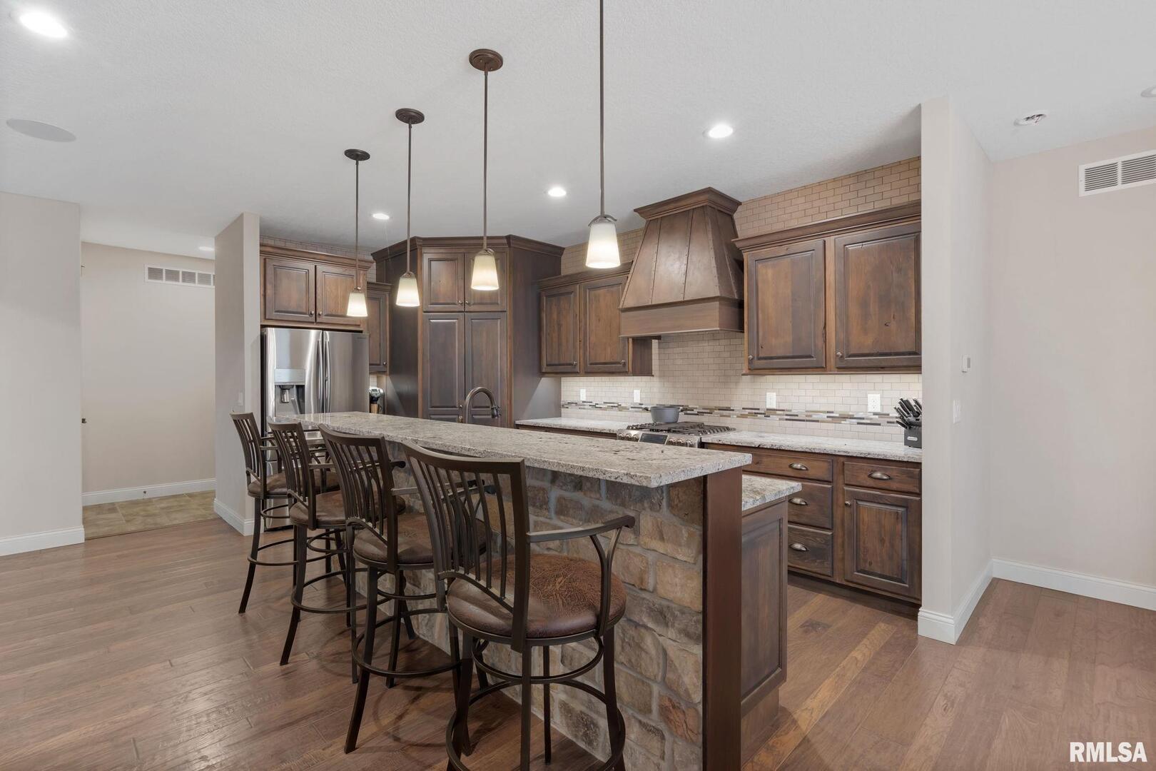 1422 Racine Court Davenport, IA 52804 - Photo 11 of 53 a kitchen with a table chairs sink and wooden floor