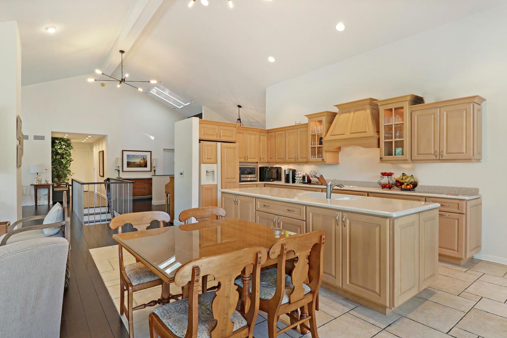 30 West Mundhank Road South Barrington, IL 60010 - Photo 21 of 45 a kitchen with stainless steel appliances kitchen island granite countertop a table chairs sink and cabinets