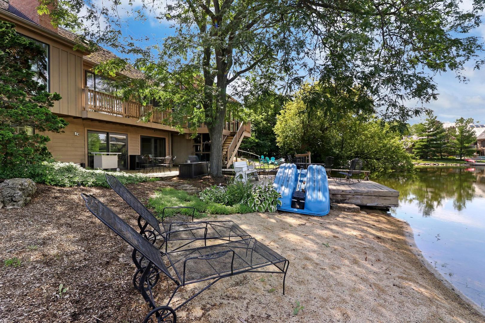 30 West Mundhank Road South Barrington, IL 60010 - Photo 7 of 45 a view of a chair and tables in the patio next to a lake