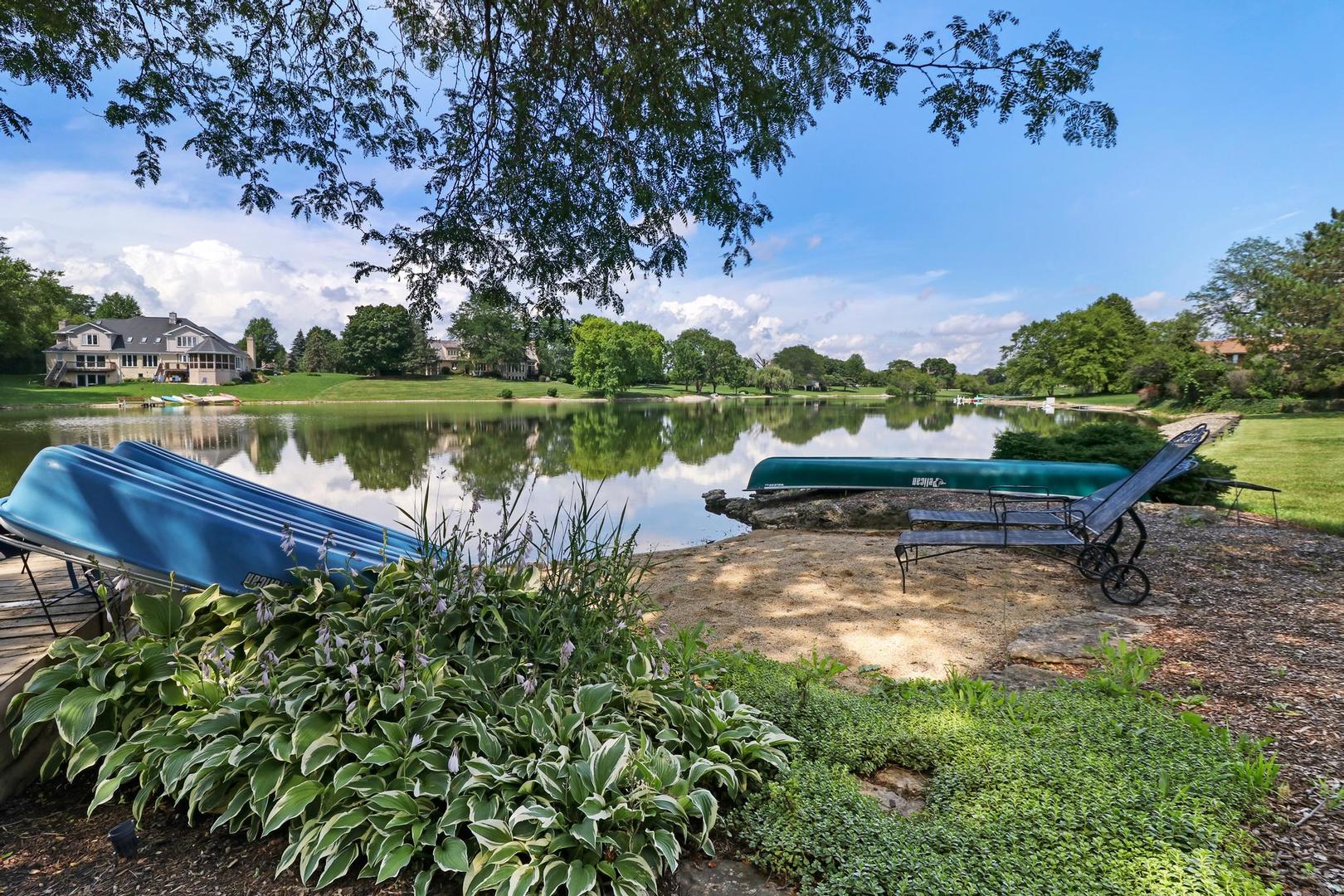 30 West Mundhank Road South Barrington, IL 60010 - Photo 10 of 45 a view of a lake with a bench in a lake