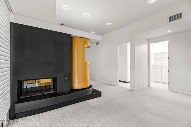 a kitchen with stainless steel appliances a stove a sink and white cabinets