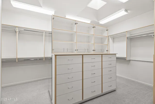 a view of walk in closet with empty racks