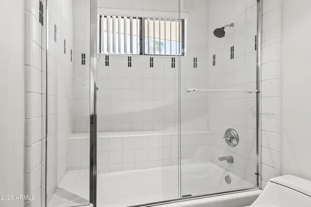 a kitchen with stainless steel appliances granite countertop a sink a refrigerator and a stove