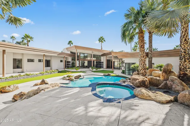 a view of a swimming pool with a yard