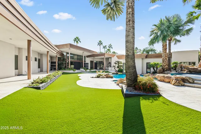 a view of a house with a yard and fountain