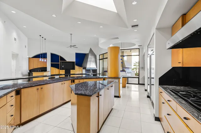 a kitchen with stainless steel appliances a stove a sink a microwave and a refrigerator